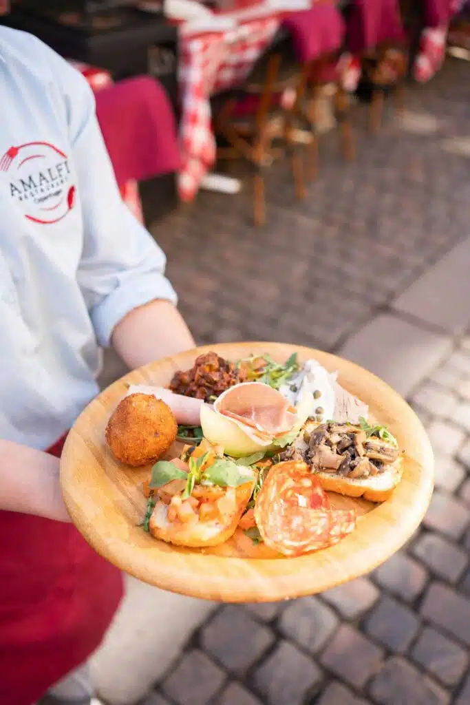 Antipasti plate with cheese, ham and vegetables
